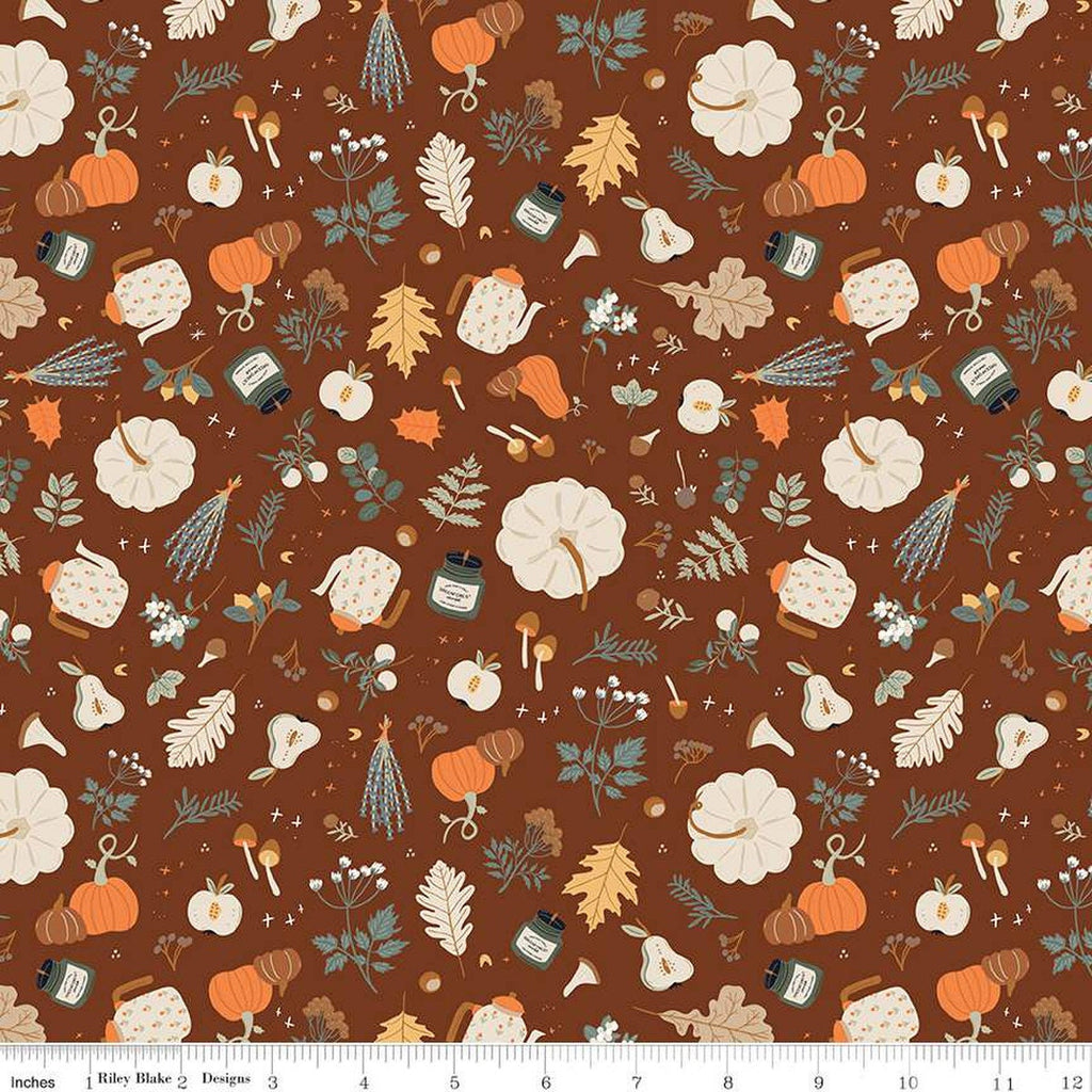 Image of brown colored quilting cotton fabric for the Pumpkin Spice collection by Riley Blake Designs. Features scattered pumpkins, flowers, and apples, mushrooms, leaves, and candles on a brown background. 
Cute Little Fabric Shop
