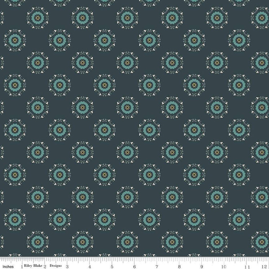 Navy, ink, night colored quilting cotton fabric with circular floral wreathes that are light teal, yellow, and white. 
Cute Little Fabric Shop