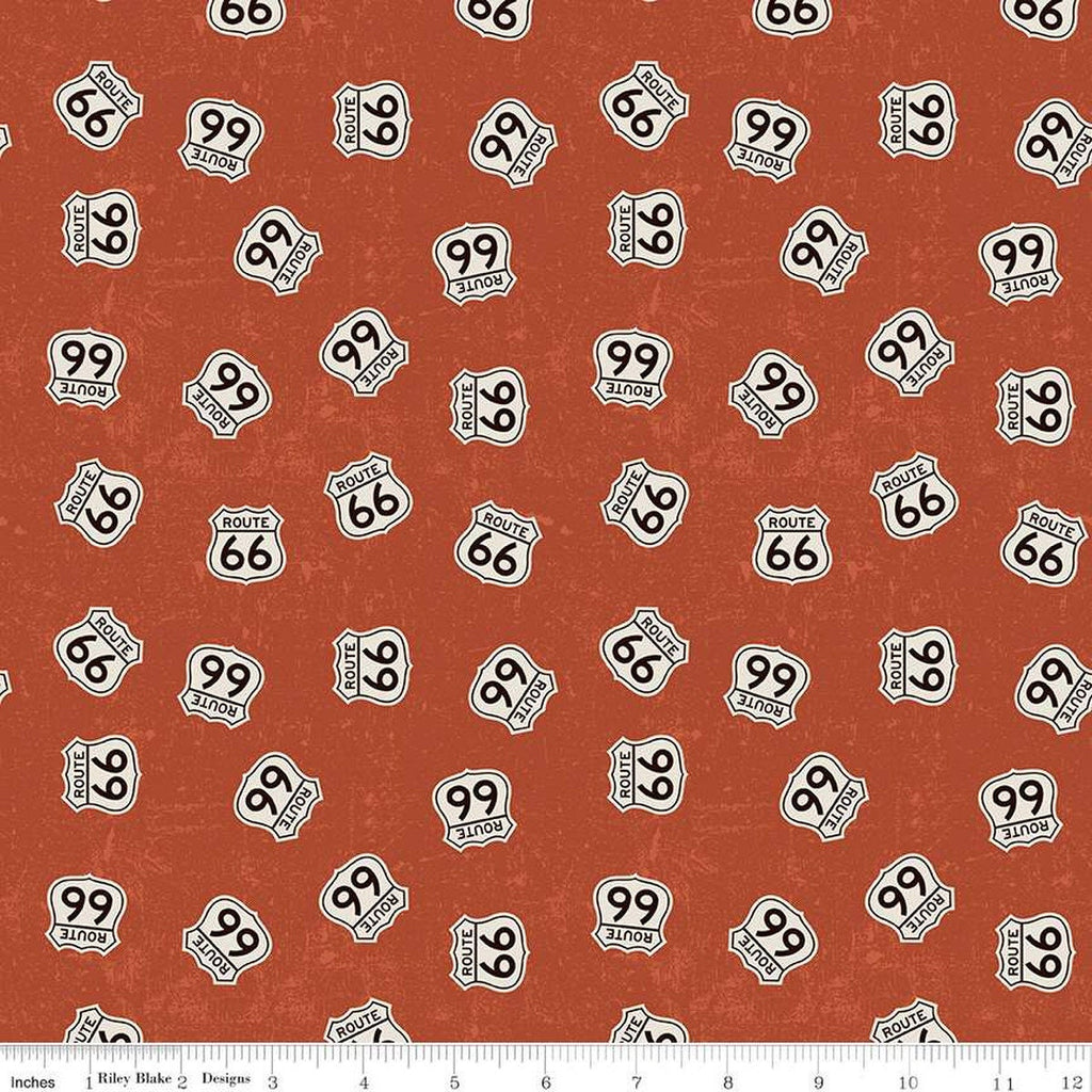 Rust, red colored quilting cotton fabrics with scattered Route 66 signs. 
Cute Little Fabric Shop