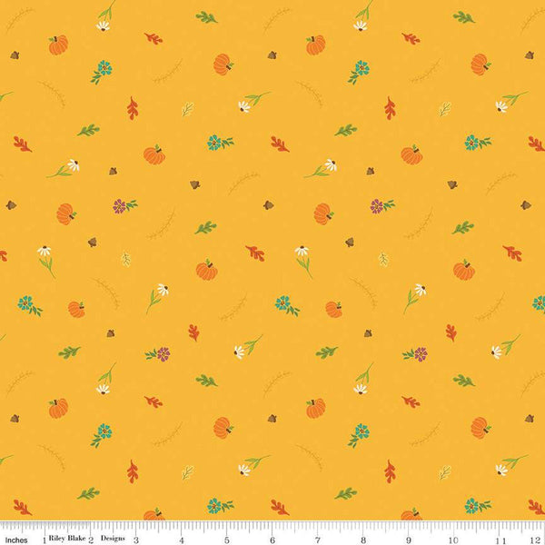 Image of the Autumn Afternoon Fall Toss Saffron quilting cotton fabric by Heather Peterson for Riley Blake Designs. Features scattered flowers, pumpkins, and acorns on a yellow background. 
Cute Little Fabric Shop