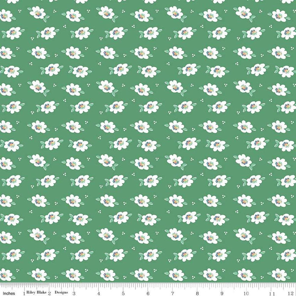 Image of the Always in Season Daisy Green quilting cotton fabric by American Jane for Riley Blake Designs. Features scattered blossoms and dots on a green background. 
Cute Little Fabric Shop