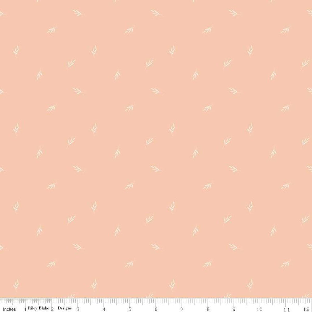 Image of the Garden Dreams Leaf Toss Peaches 'n Cream quilting cotton fabric by Amber Elliot for Riley Blake Designs. Features leaves scattered on a light pink orange background. 
Cute Little Fabric Shop