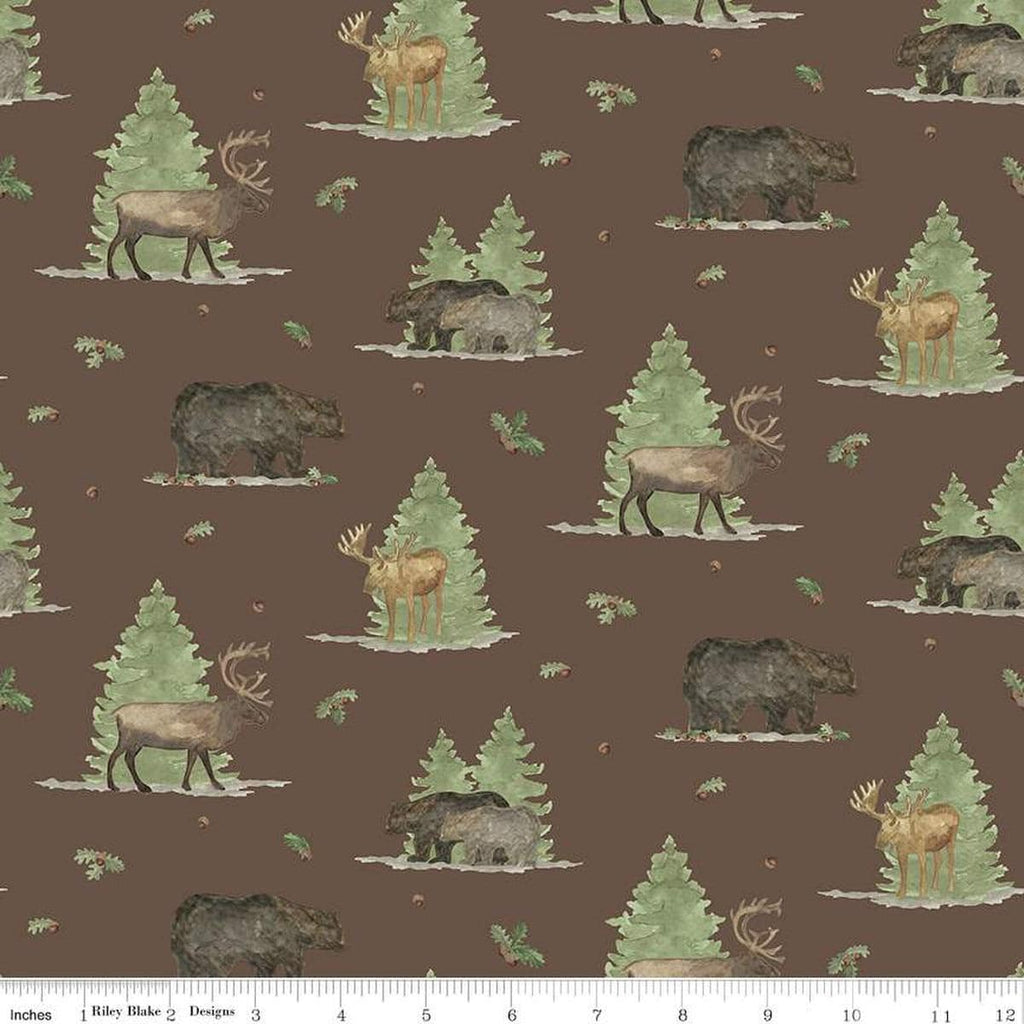 Image of the Lets Get Lost in the Woods Main Brown quilting cotton fabric by Tara Reed for Riley Blake Designs. Features  big game animals on a background with trees and oak leaves and acorns on a dark brown background. 
Cute Little Fabric Shop