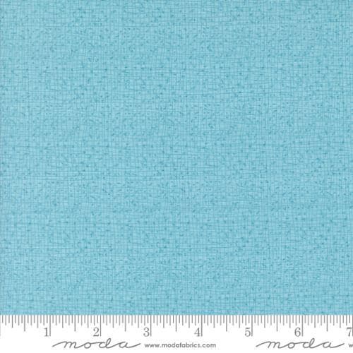 Thatched Frost quilting cotton fabric by Gingiber for Moda Fabrics. Features a textured and lined pattern on a light aqua blue background. 
Cute Little Fabric Shop