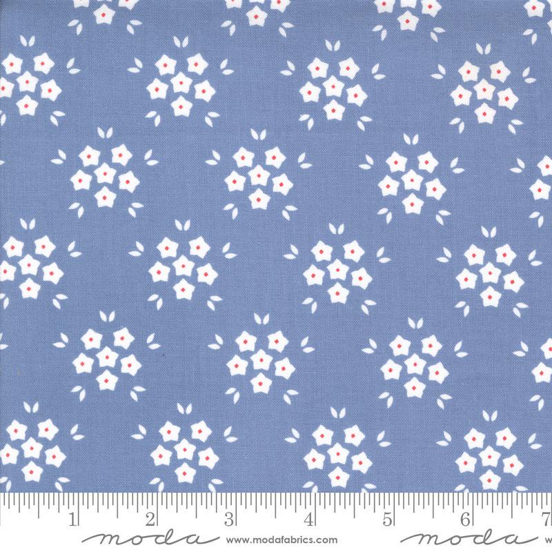 Image of the Hollyhocks Roses Puffs Sky quilting cotton fabric by Moda Fabrics. Features small flowers on a blue background. 
Cute Little Fabric Shop