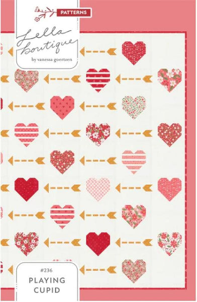 Image of the Playing Cupid quilt pattern by Lella Boutique for Moda Fabrics. Features hearts and arrows on a quilt. 
Cute Little Fabric Shop