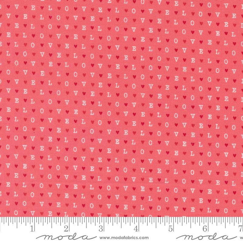Image of the Love Blooms LOVE Lipstick quilting cotton fabric by Moda Fabrics. Features the word LOVE on a pink background. Cute Little Fabric Shop