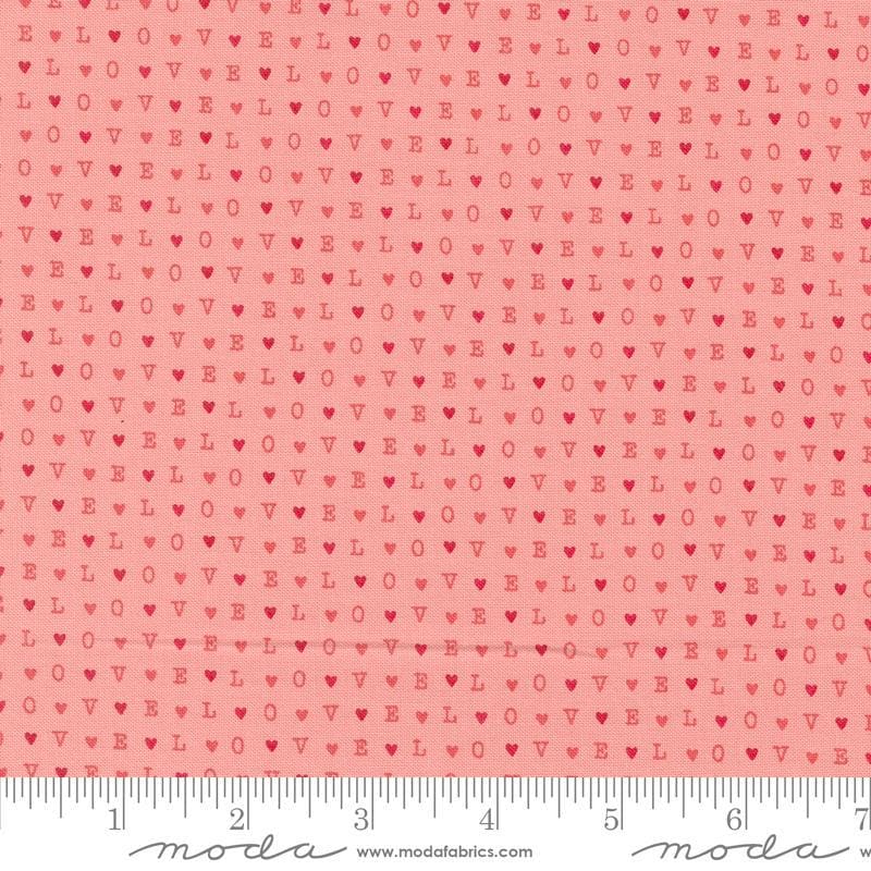 Image of the Love Blooms LOVE Blush quilting cotton fabric by Moda Fabrics. Features the word LOVE on a pink background. Cute Little Fabric Shop