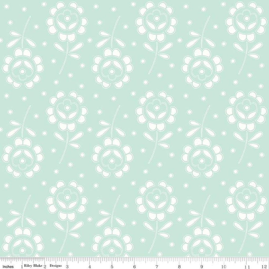 Image of the Sewing Seeds III Rose Cutwork Aqua quilting cotton fabric by Lori Holt for Riley Blake Designs. Features flowers on a pink background. Cute Little Fabric Shop