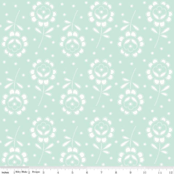 Image of the Sewing Seeds III Rose Cutwork Aqua quilting cotton fabric by Lori Holt for Riley Blake Designs. Features flowers on a pink background. Cute Little Fabric Shop