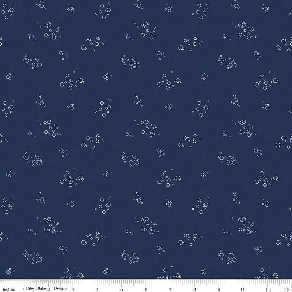 Image of the Yacht Club Bubbles Navy quilting cotton fabric by Amanda Niederhauser for Riley Blake Designs. Features circles on a blue background. Cute Little Fabric Shop