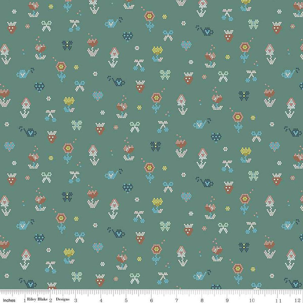 Image of the Sunsetridge Mosaic Lodge Pole quilting cotton fabric by Minki Kim for Riley Blake Designs. Features pixels on a green background. Cute Little Fabric Shop