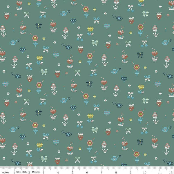 Image of the Sunsetridge Mosaic Lodge Pole quilting cotton fabric by Minki Kim for Riley Blake Designs. Features pixels on a green background. Cute Little Fabric Shop