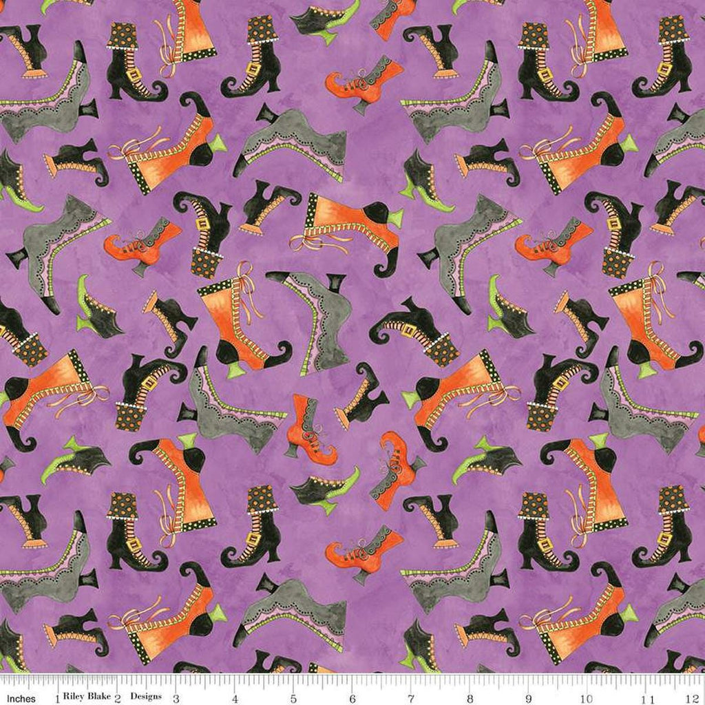 Image of the Ghoul Friends Boots Toss Purple quilting cotton fabric by Teresa Kogut for Riley Blake Designs. Features boots on a purple background. Cute Little Fabric Shop