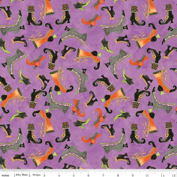 Image of the Ghoul Friends Boots Toss Purple quilting cotton fabric by Teresa Kogut for Riley Blake Designs. Features boots on a purple background. Cute Little Fabric Shop