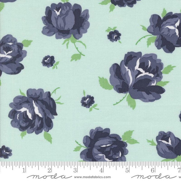 Image of the Summertime Rosie Ice quilting cotton fabric by Moda Fabrics. Features flowers on a blue background. Cute Little Fabric Shop