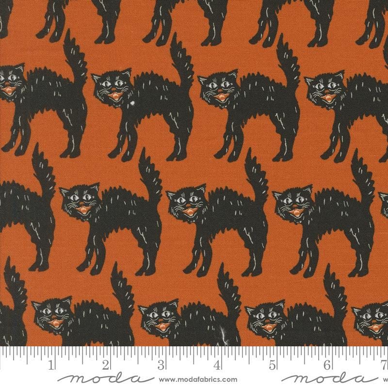 Image of the Home Sweet Haunt Black Cat Rust quilting cotton fabric by Moda Fabrics. Features scats on an orange background. Cute Little Fabric Shop