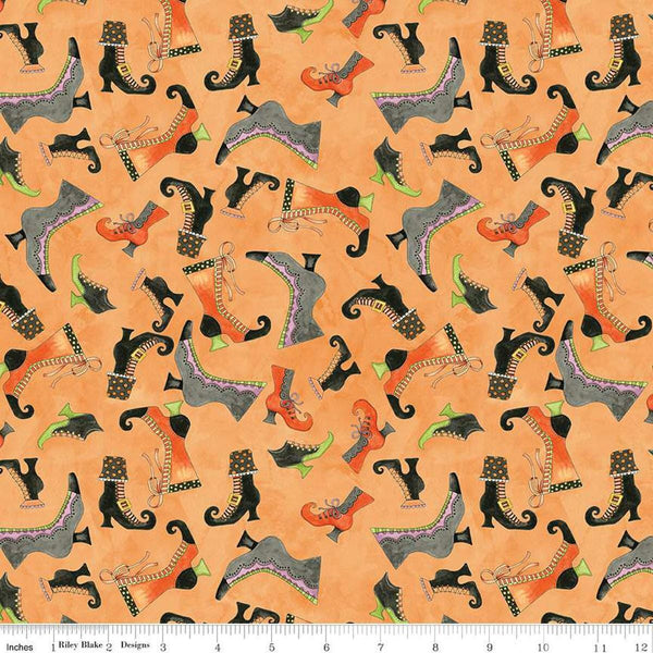 Image of the Ghoul Friends Boots Toss Orange quilting cotton fabric by Teresa Kogut for Riley Blake Designs. Features boots on an orange background. Cute Little Fabric Shop