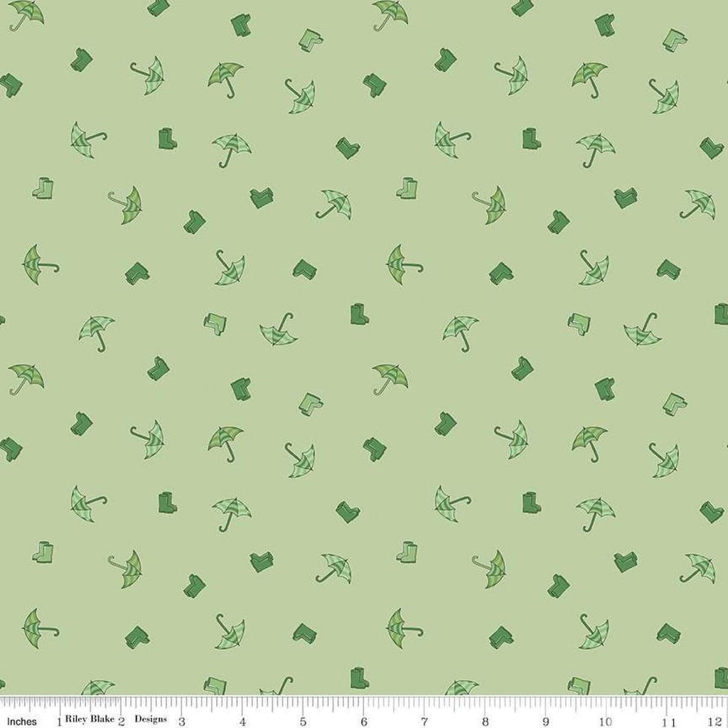 Image of the Cloudburst Umbrellas Green quilting cotton fabric by Riley Blake Designs. Features rainboots on a green background. Cute Little Fabric Shop