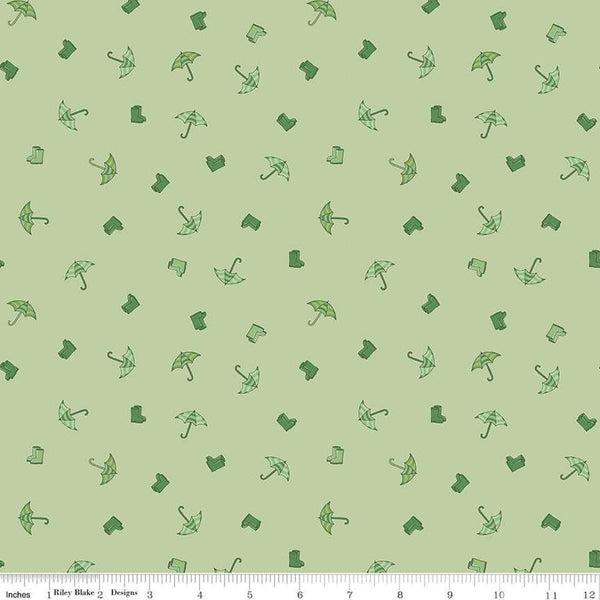 Image of the Cloudburst Umbrellas Green quilting cotton fabric by Riley Blake Designs. Features rainboots on a green background. Cute Little Fabric Shop