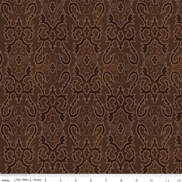 Image of John Wayne American West Boot Stitching Brown quilting cotton fabric by Riley Blake Official Product for Riley Blake Designs. Features printed embroidery on a brown background. Cute Little Fabric Shop