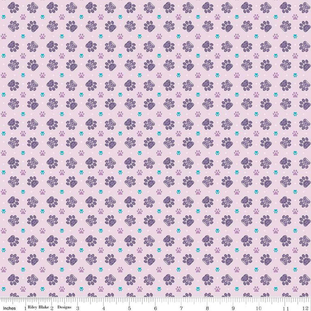 Image of Celtic Cats Paws Lilac quilting cotton fabric by Brigid Ashwood for Riley Blake Designs. Features pawprints on a purple background. Cute Little Fabric Shop