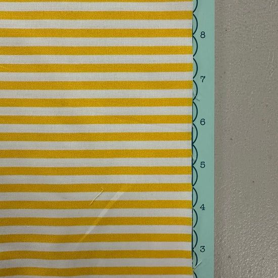 a close up of a yellow and white striped fabric