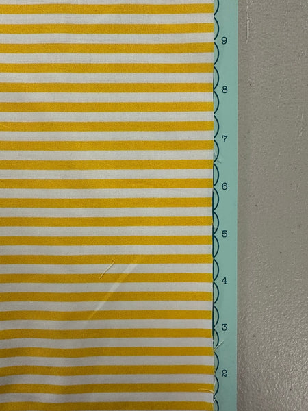 a close up of a yellow and white striped fabric