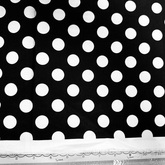 a black and white photo of a polka dot fabric