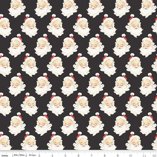Charcoal quilting cotton with Santa Claus heads with beards, red hats, and a smile. 
Cute Little Fabric Shop