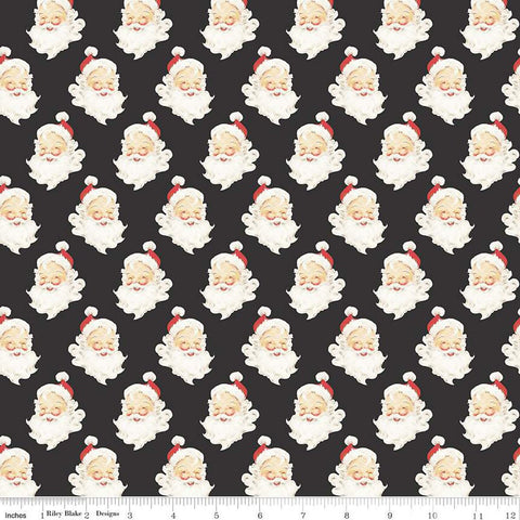 Charcoal quilting cotton with Santa Claus heads with beards, red hats, and a smile. 
Cute Little Fabric Shop