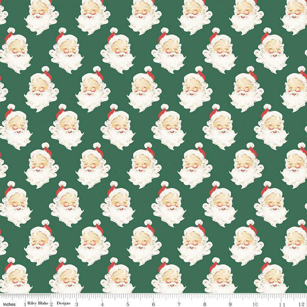 Green quilting cotton with Santa Claus heads with beards, red hats, and a smile. 
Cute Little Fabric Shop