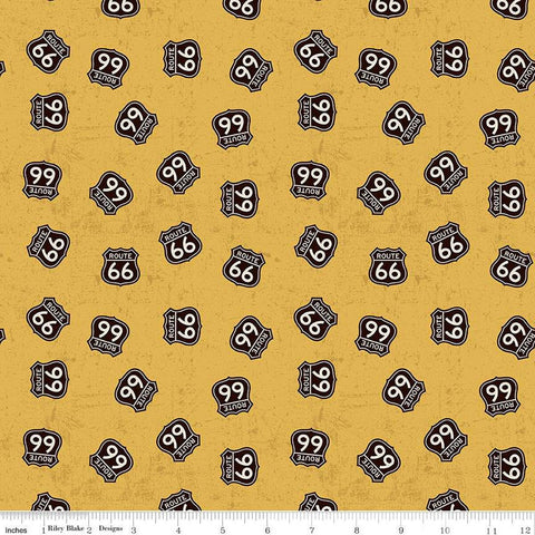 Gold, yellow colored quilting cotton fabric with Route 66 signs scattered around. 
Cute Little Fabric Shop