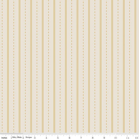 Cream, tan colored fabric with yellow dashed lines and stripes. 
Cute Little Fabric Shop