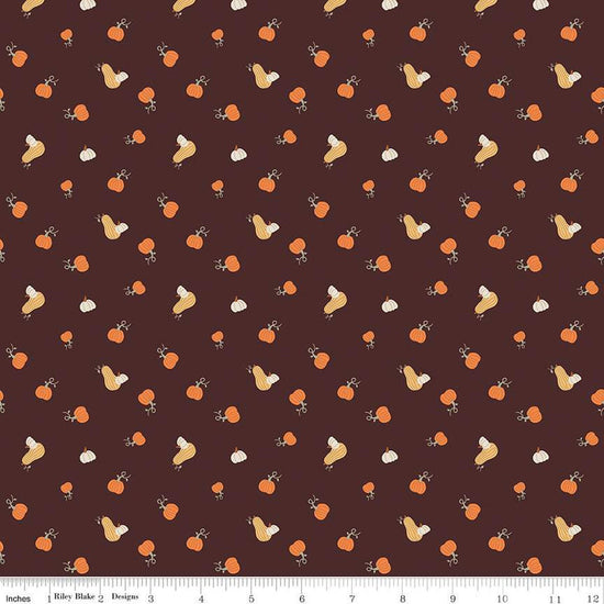 Image of espresso brown colored quilting cotton fabric for the Pumpkin Spice collection by Riley Blake Designs. Features scattered and tossed orange, yellow, and cream pumpkins on the espresso background. 
Cute Little Fabric Shop