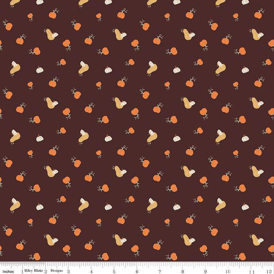 Image of espresso brown colored quilting cotton fabric for the Pumpkin Spice collection by Riley Blake Designs. Features scattered and tossed orange, yellow, and cream pumpkins on the espresso background. 
Cute Little Fabric Shop
