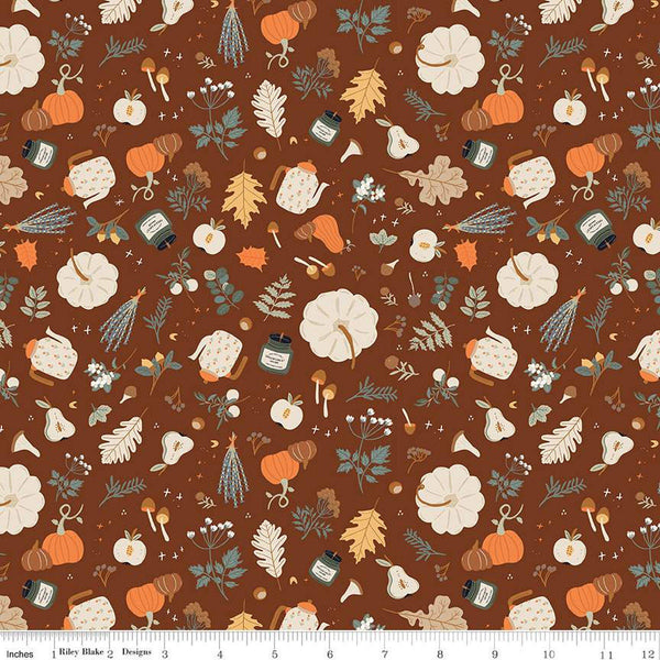 Image of brown colored quilting cotton fabric for the Pumpkin Spice collection by Riley Blake Designs. Features scattered pumpkins, flowers, and apples, mushrooms, leaves, and candles on a brown background. 
Cute Little Fabric Shop