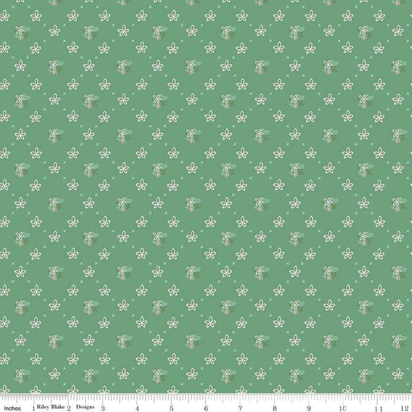 Clover Farm from Riley Blake Designs. Image depicts scattered flowers and Xs on a green background. Quilting cotton fabric. 
Cute Little Fabric Shop