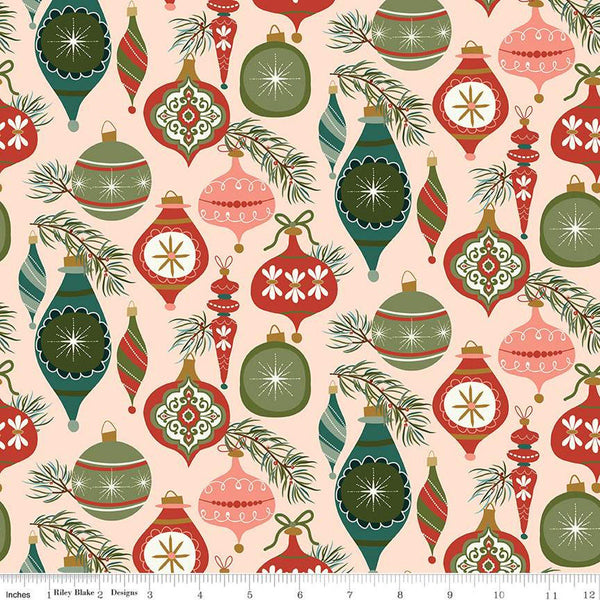 Image of Christmas Is in Town Ornaments Blush by Riley Blake Designs. Features Christmas ornaments on a light blush background with sprigs of pine needles. 
Cute Little Fabric Shop