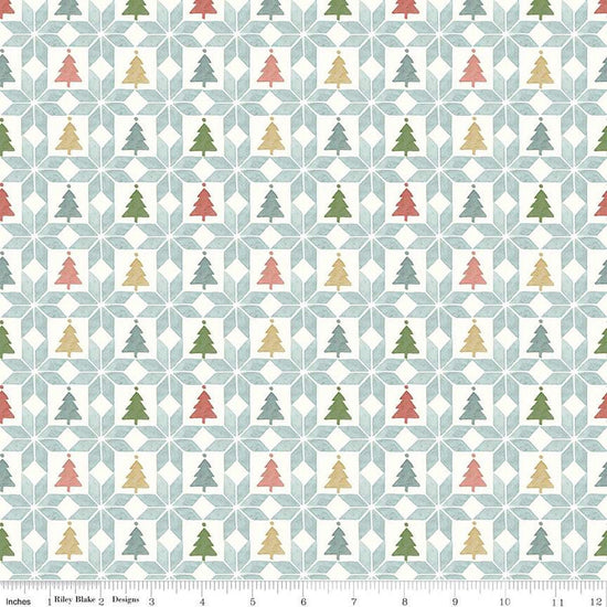 Image of the Magical Winterland Patchwork Multi quilting cotton fabric by Riley Blake Designs. Features a quilt design with trees and stars on a light blue background. 
Cute Little Fabric Shop