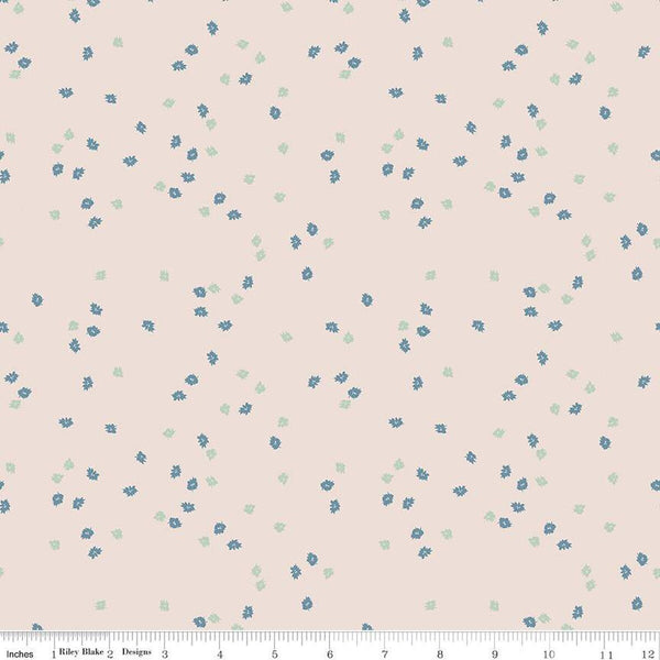 Light pink natural colored quilting cotton fabric with green and blue small scattered flowers.Cute Little Fabric Shop