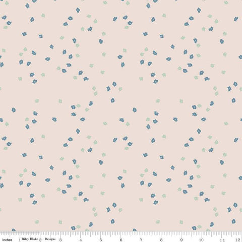 Light pink natural colored quilting cotton fabric with green and blue small scattered flowers.Cute Little Fabric Shop