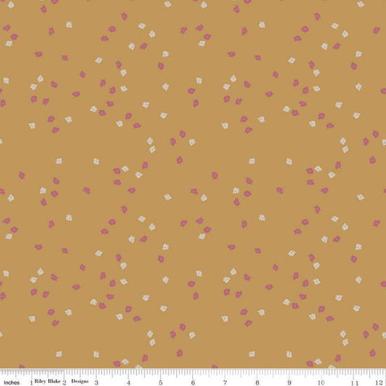 Dark yellow, honey colored quilting cotton fabric with pink and white scattered flowers. 
Cute Little Fabric Shop