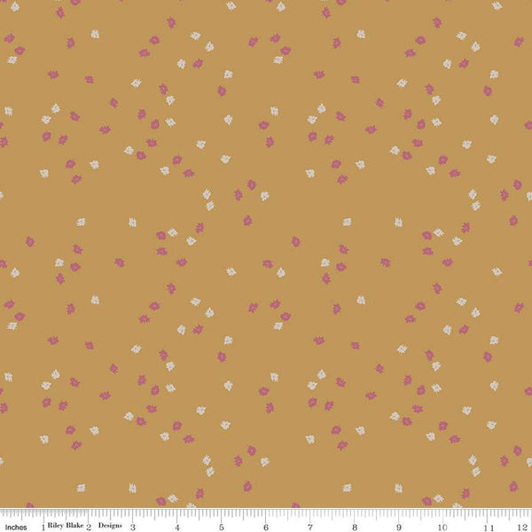 Dark yellow, honey colored quilting cotton fabric with pink and white scattered flowers. 
Cute Little Fabric Shop