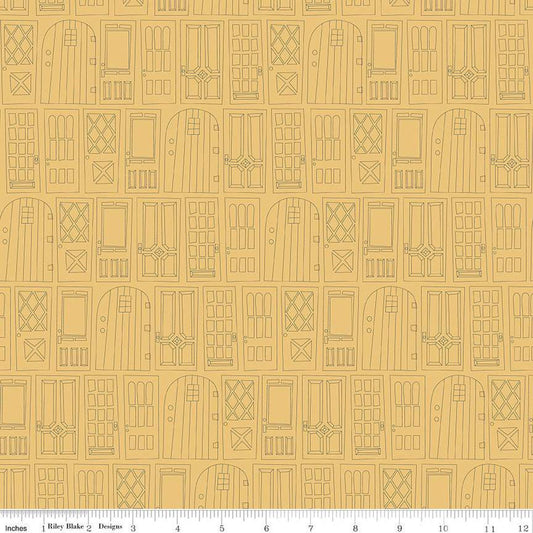 Light yellow, honey colored fabric with outlined front doors together in rows. 
Cute Little Fabric Shop