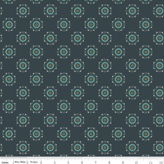 Navy, ink, night colored quilting cotton fabric with circular floral wreathes that are light teal, yellow, and white. 
Cute Little Fabric Shop