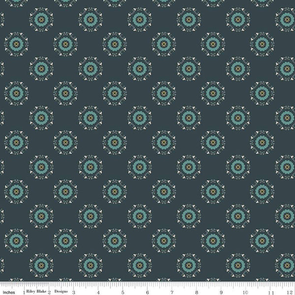 Navy, ink, night colored quilting cotton fabric with circular floral wreathes that are light teal, yellow, and white. 
Cute Little Fabric Shop