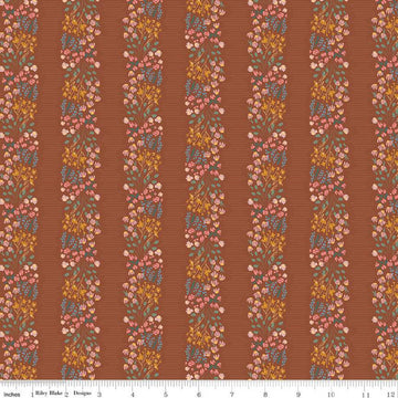 Copper colored quilting cotton fabric with stripes of clustered green, pink, blue, and yellow flowers. 
Cute Little Fabric Shop