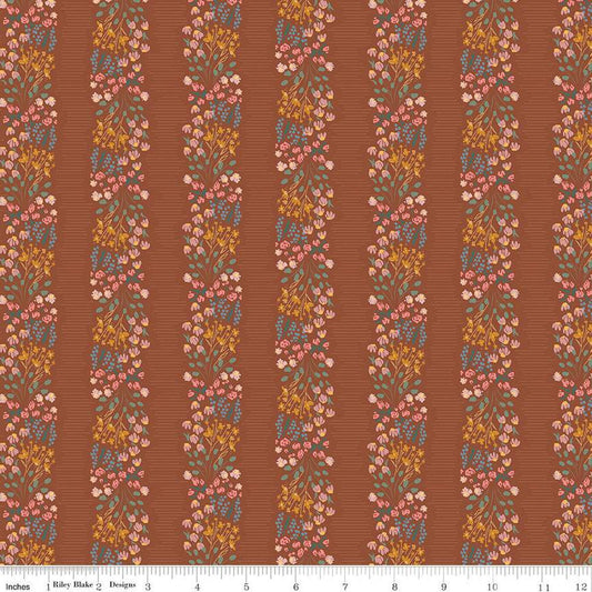 Copper colored quilting cotton fabric with stripes of clustered green, pink, blue, and yellow flowers. 
Cute Little Fabric Shop