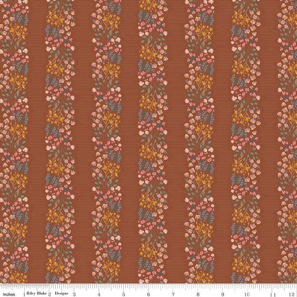 Copper colored quilting cotton fabric with stripes of clustered green, pink, blue, and yellow flowers. 
Cute Little Fabric Shop